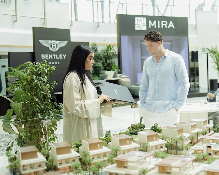Sem May reviewing a development model with a client